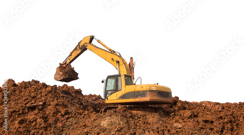 The large yellow excavator is working on the earth heap