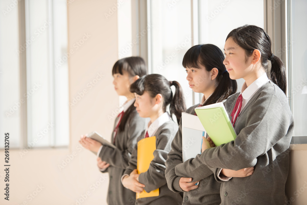 窓際に寄りかかる女子学生 Stock Photo Adobe Stock