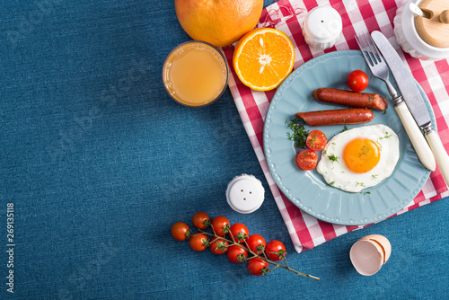 Healthy breakfast with fried eggs, griled sausages, tomato photo
