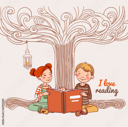 Cute boy and girl reading a book under the tree 