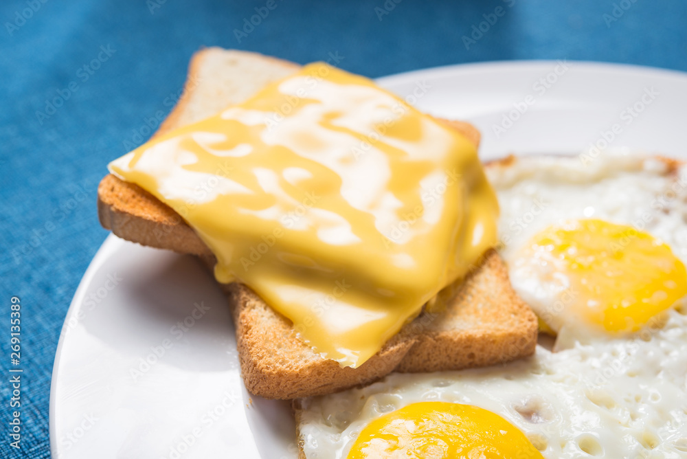Closeup of fried eggs and toast cheese