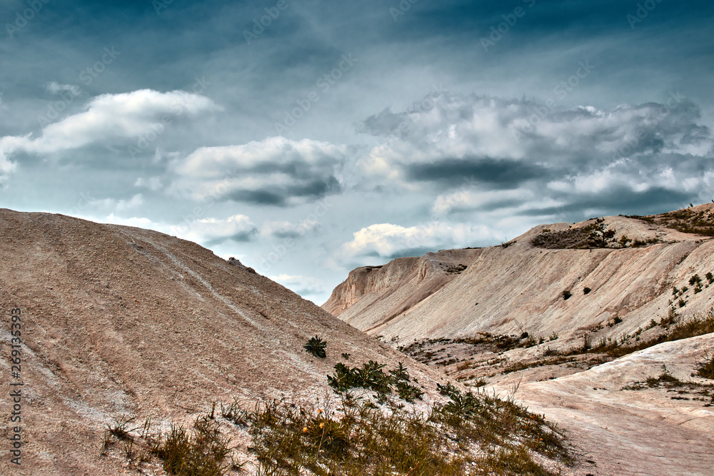 white limestone quarry on a background of blue sky with clouds