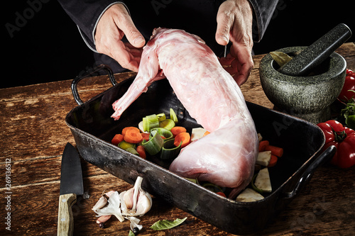 Chef preparing a skinned cleaned wild rabbit photo