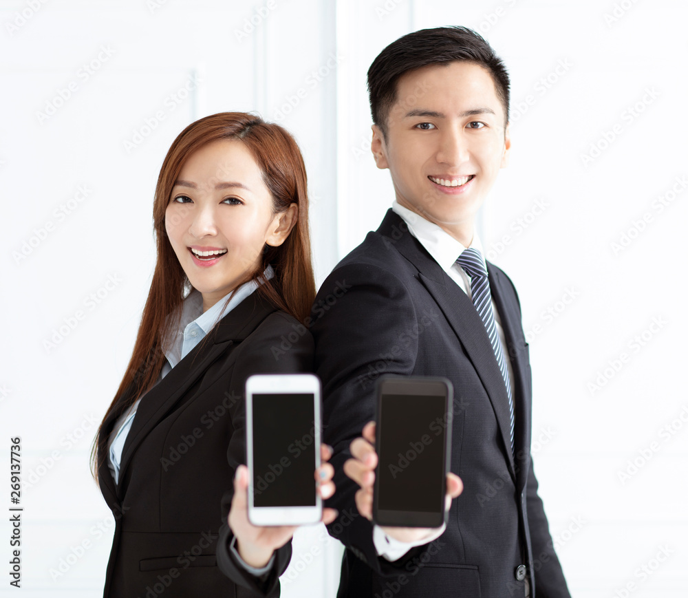 Young smiling businesswoman and businessman showing smart phone Young smiling businesswoman and businessman showing smart phone