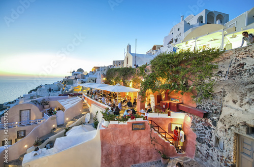 SANTORINI, GREECE - JUNE 2014: Sunset view of Oia buildings and streets. Oia is the major tourist attraction on the island photo