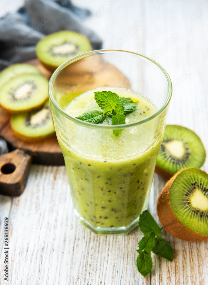 Glass of kiwi smoothie with fresh fruits Glass of kiwi smoothie with fresh fruits