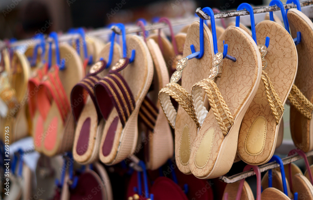  Closeup Indian woman fashion chappal or  footwear in display outdoors in front of a retail shop      