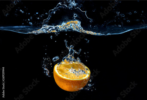 Orange with fresh water splash with man water figure