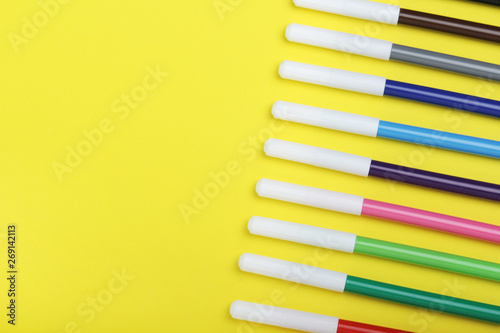 Multicolored markers at bright background