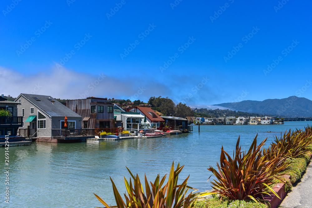 House boats floating on water on a sunny day in Sausalito, San Francisco bay, USA House boats floating on water on a sunny day in Sausalito, San Francisco bay, USA