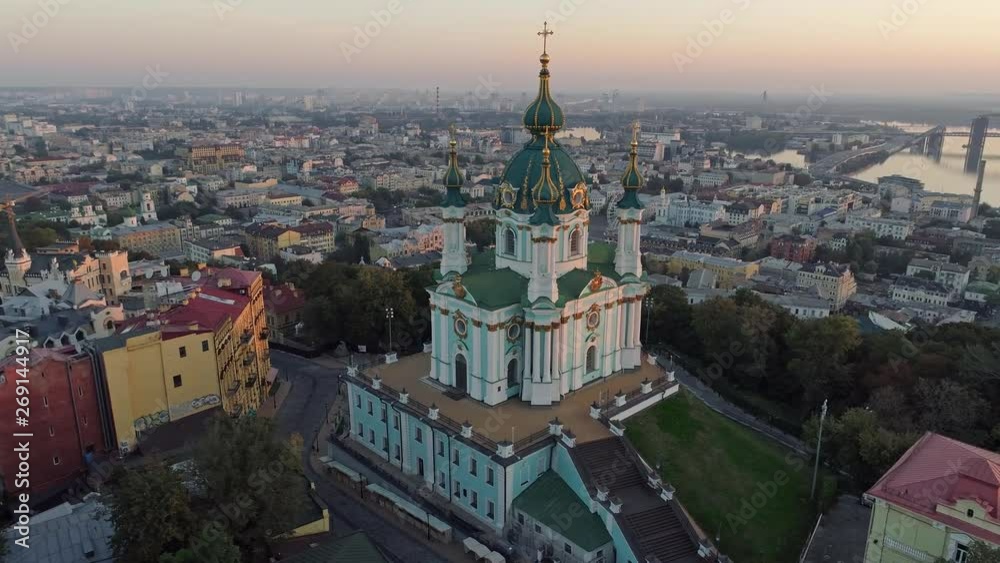 Flying around St. Andrew's Church in Podil district near the bank of Dnieper in Kyiv (Kiev), Ukraine during sunrise. Aerial shot, 4K Flying around St. Andrew's Church in Podil district near the bank of Dnieper in Kyiv (Kiev), Ukraine during sunrise. Aerial shot, 4K