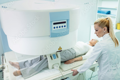 Wallpaper Mural Medical technician making preparations for knee MRI scan of a patient at clinic. Torontodigital.ca