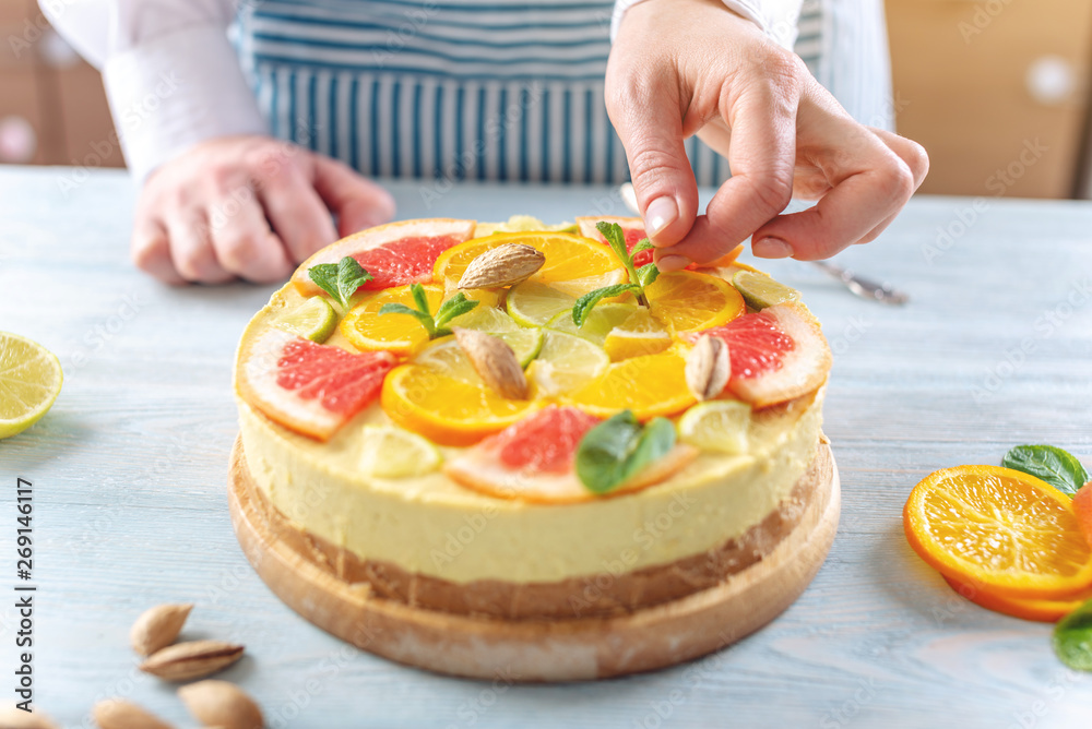 Raw citrus cake with grapefruit, orange, lime and lemon with nuts and mint. Healthy fresh summer dessert