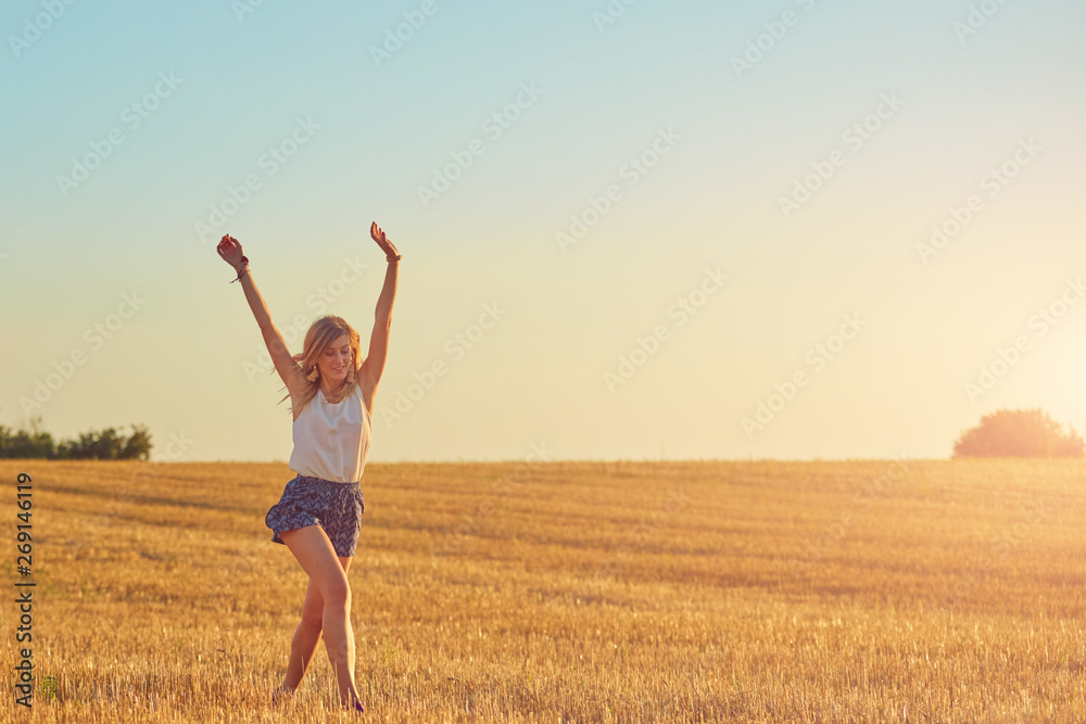 Young woman jumping and running in a wheat field. Young woman jumping and running in a wheat field.