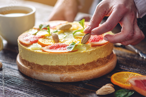 Raw citrus cake with grapefruit  orange  lime and lemon with nuts and mint. Healthy fresh summer dessert. Vegan food