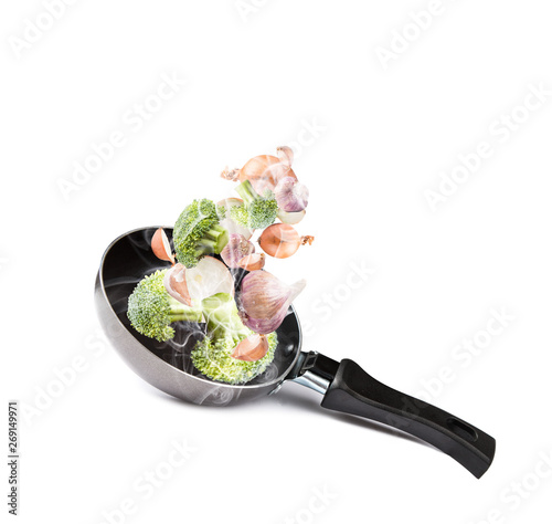 Frying pan with flying vegetables, isolated on white backfground – image photo