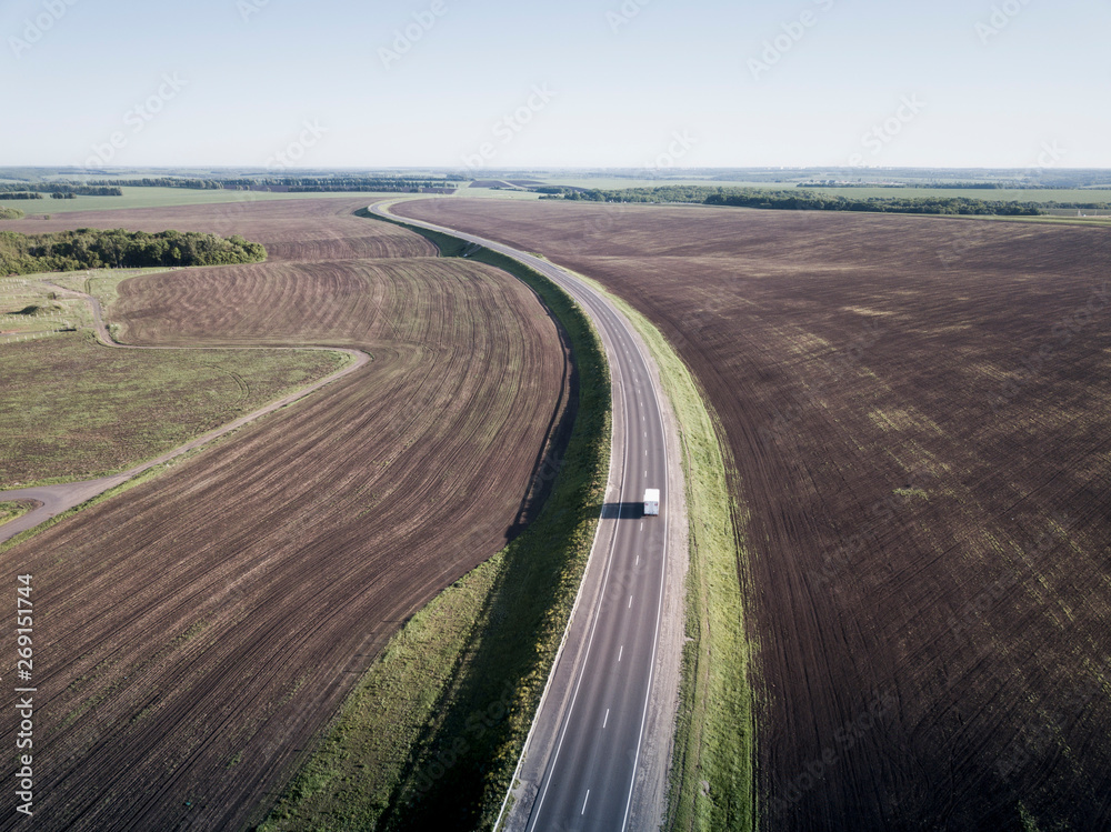 Top view of the field road with car. Aerial