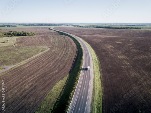 Top view of the field road with car. Aerial