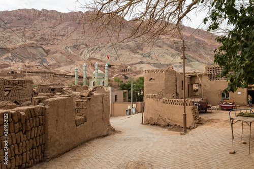 Tuyoq village (Tuyuk): one of the streets of this traditional uighur village set in a lush valley cutting through the flaming mountains near Turpan, Xinjiang, China photo