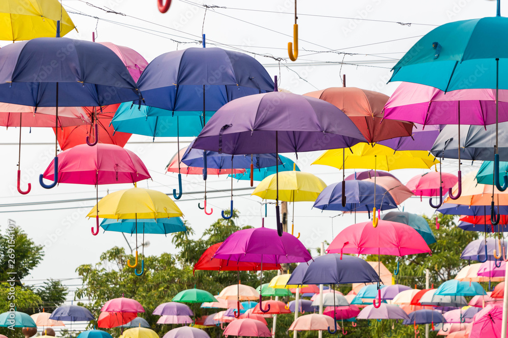 Colorful umbrellas hanging on the rope.