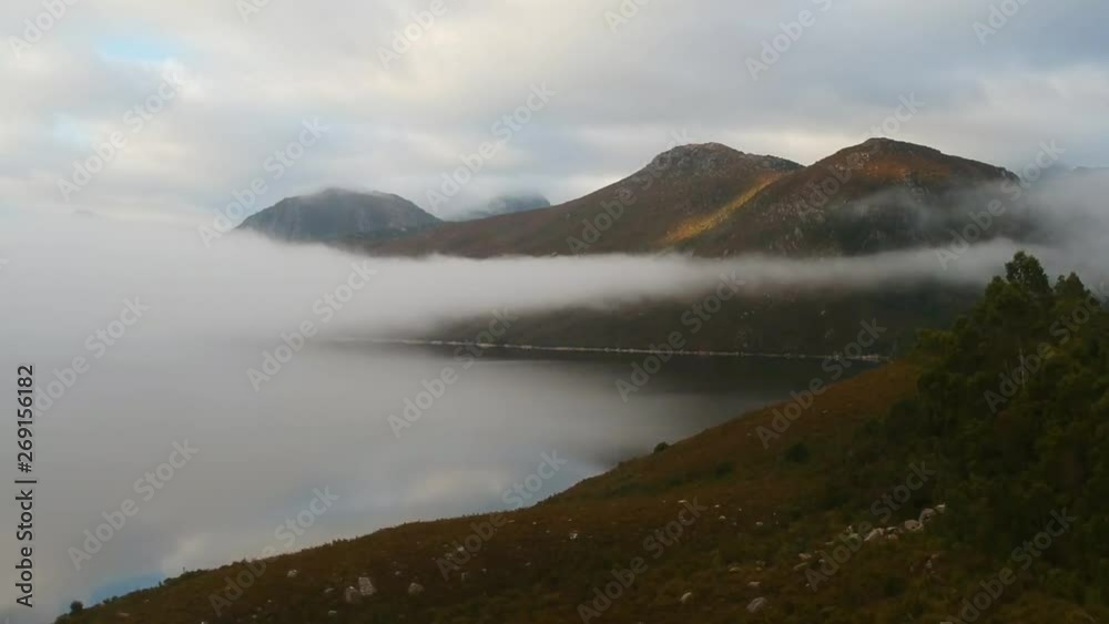 Flying over the banks of a lake with foggy mist covering the water on a cold winters day