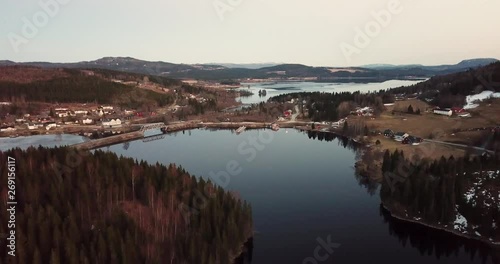 Drone footage over the lake Snaasavatnet in Norway - Scandinavia. The Lake is partly frozen in april. photo