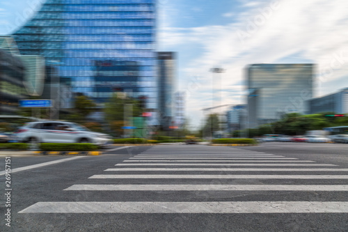 empty road with zebra crossing and skyscrapers in modern city.