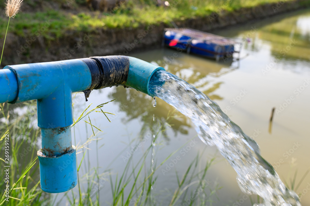 Agriculture blue pipe with groundwater gushing Agriculture blue pipe with groundwater gushing