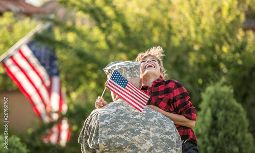 Happy reunion of soldier with family outdoors