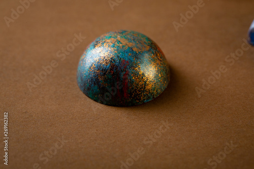 Sweet chocolate bonbons on brown background