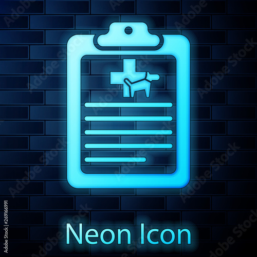 Glowing neon Clipboard with medical clinical record pet icon isolated on brick wall background. Health insurance form. Medical check marks report. Vector Illustration