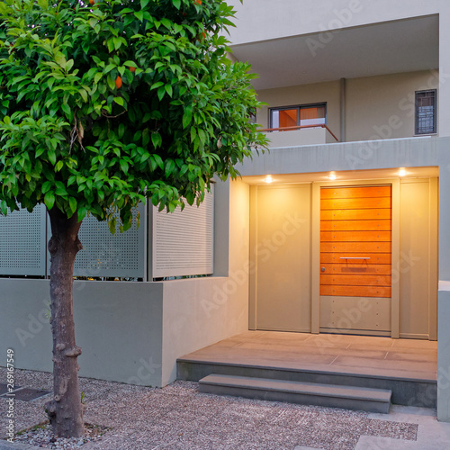 contemporary design apartment building entrance door, illuminated photo