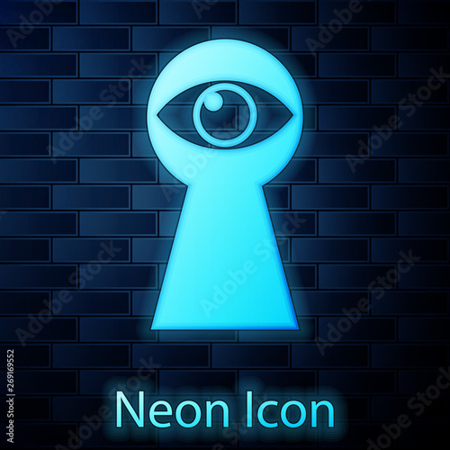 Glowing neon Keyhole with eye icon isolated on brick wall background. The eye looks into the keyhole. Keyhole eye hole. Vector Illustration