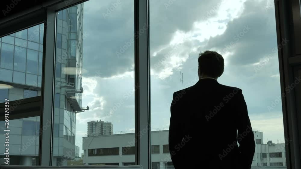 Silhouette of a man in front of the window Silhouette of a man in front of the window
