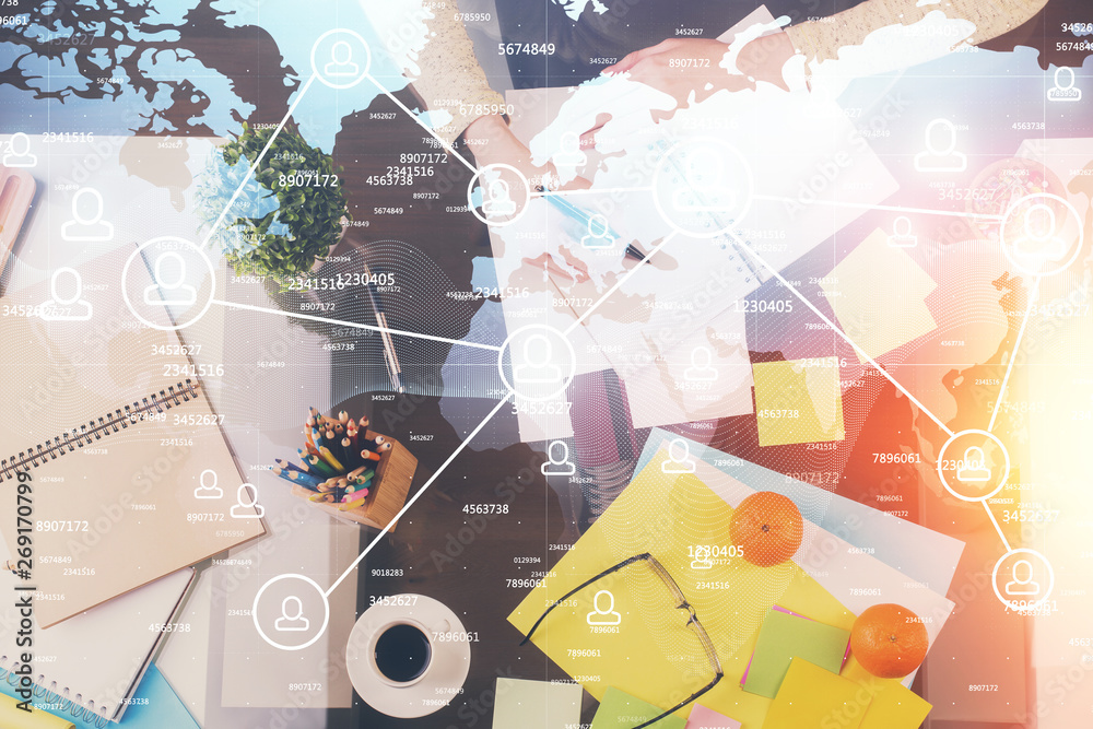 Fototapeta premium Social network theme hologram over hands taking notes background. Concept of global international people connect. Double exposure