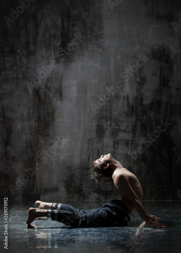 Young beautiful yoga instructor is posing in studio.