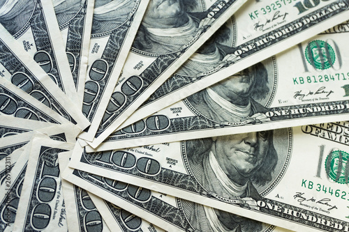 crolled stack of 100 dollar bills, close up banknote photo