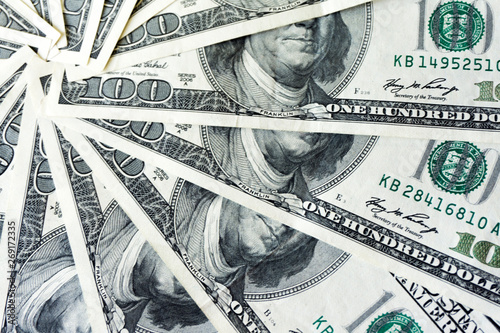 crolled stack of 100 dollar bills, close up banknote photo