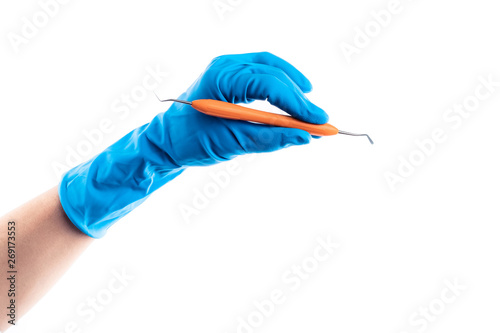 Hand in blue glove holding dental metal stick isolated on white background