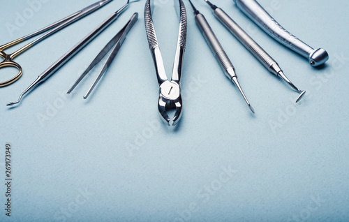 Closeup of dental metal tools on light blue background photo