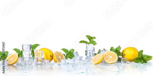 ice cubes, mint leaves with lemons isolated on a white background photo