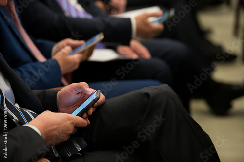 office people working on mobile phones