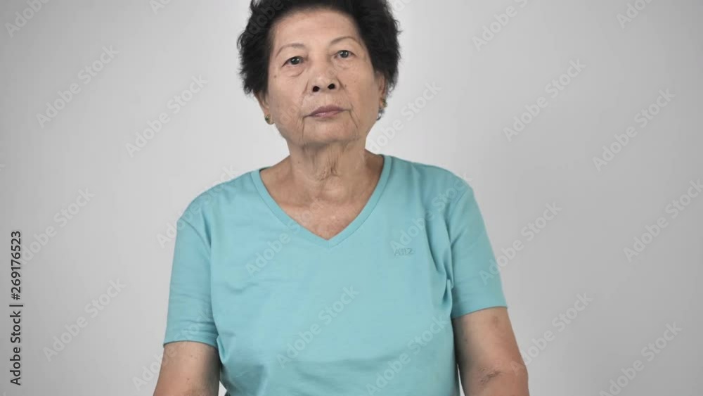 Asian senior woman doing self exercise massage at home Asian senior woman doing self exercise massage at home