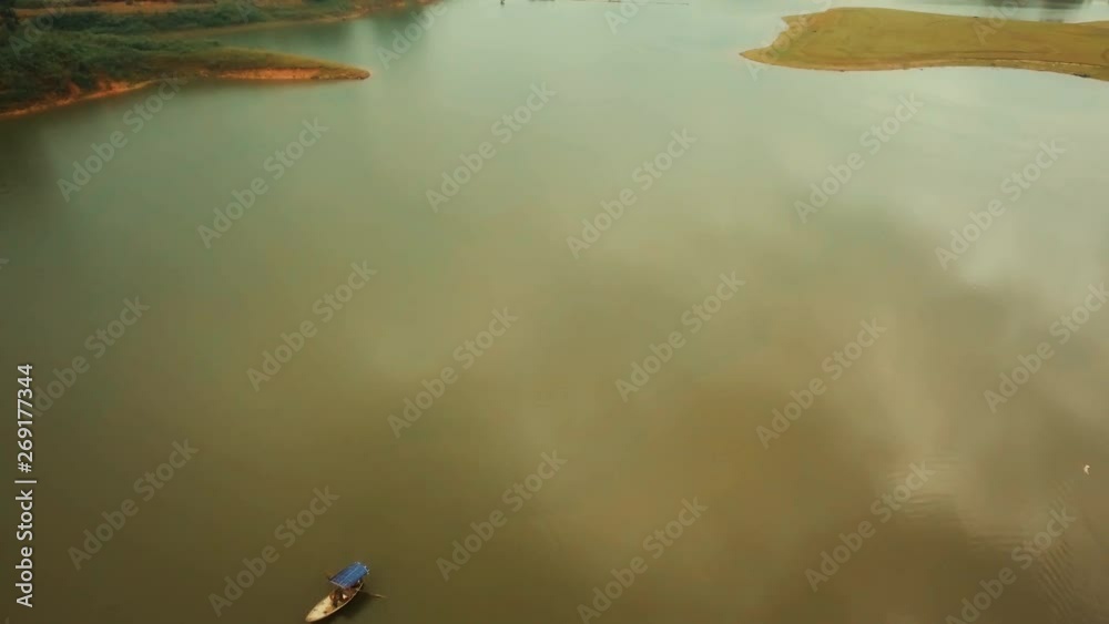 Aerial over glassy river with canoes and boats Aerial over glassy river with canoes and boats