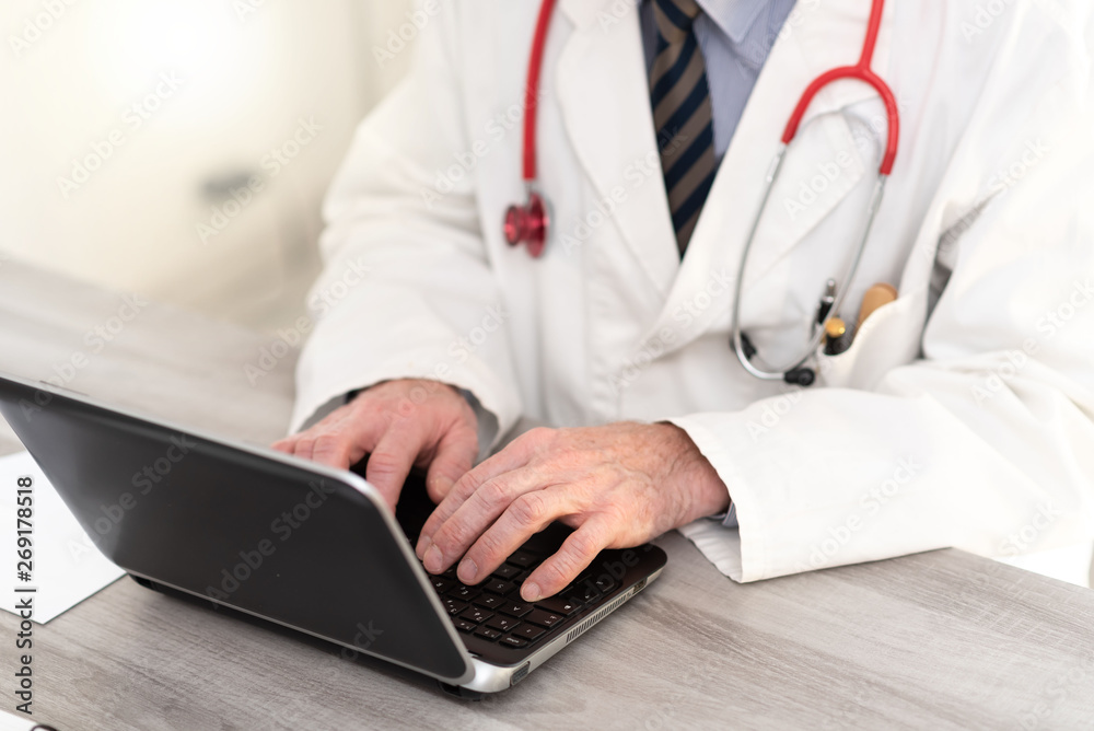 Male doctor using laptop Male doctor using laptop