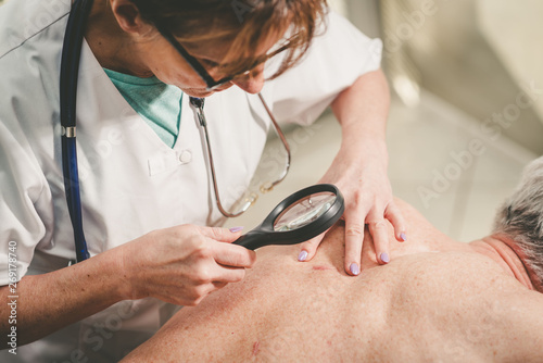 Canvas Print Dermatologist examining the skin of a patient