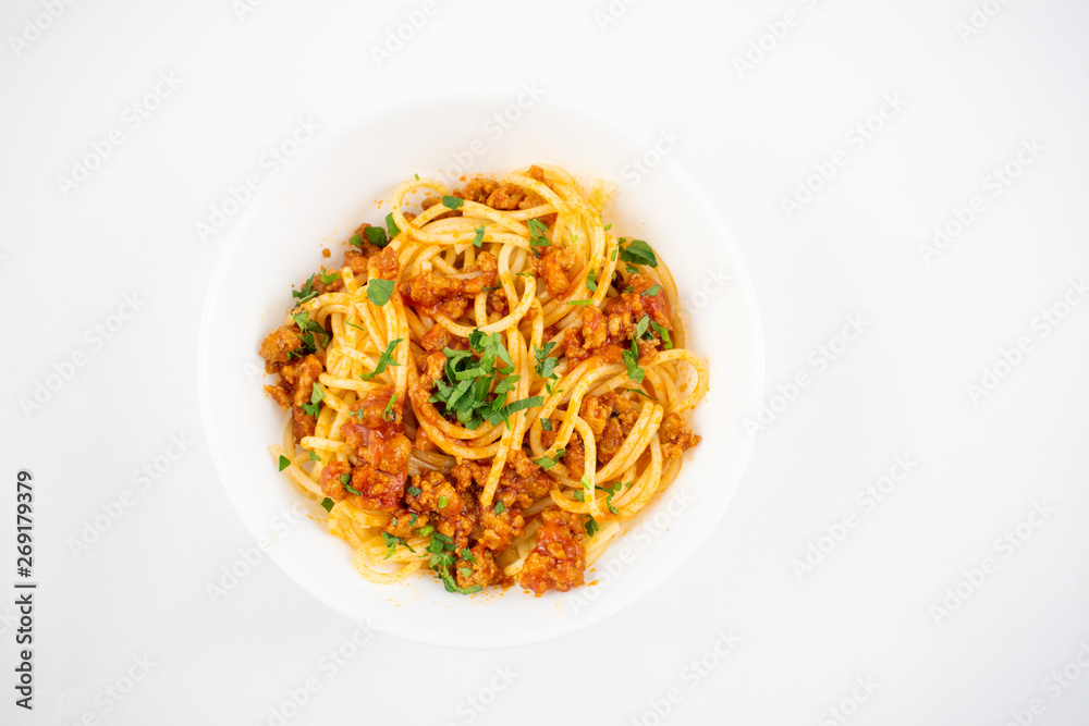Spaghetti bolognese on a white plate. Italian cuisine concept, food ingredients. Flat lay. Top view
