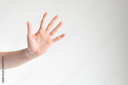 Woman showing a palm and raising five fingers on white background and copy space. © jtas