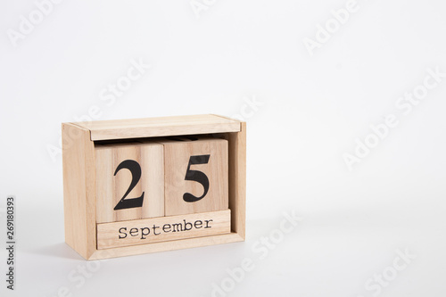 Wooden calendar September 25 on a white background