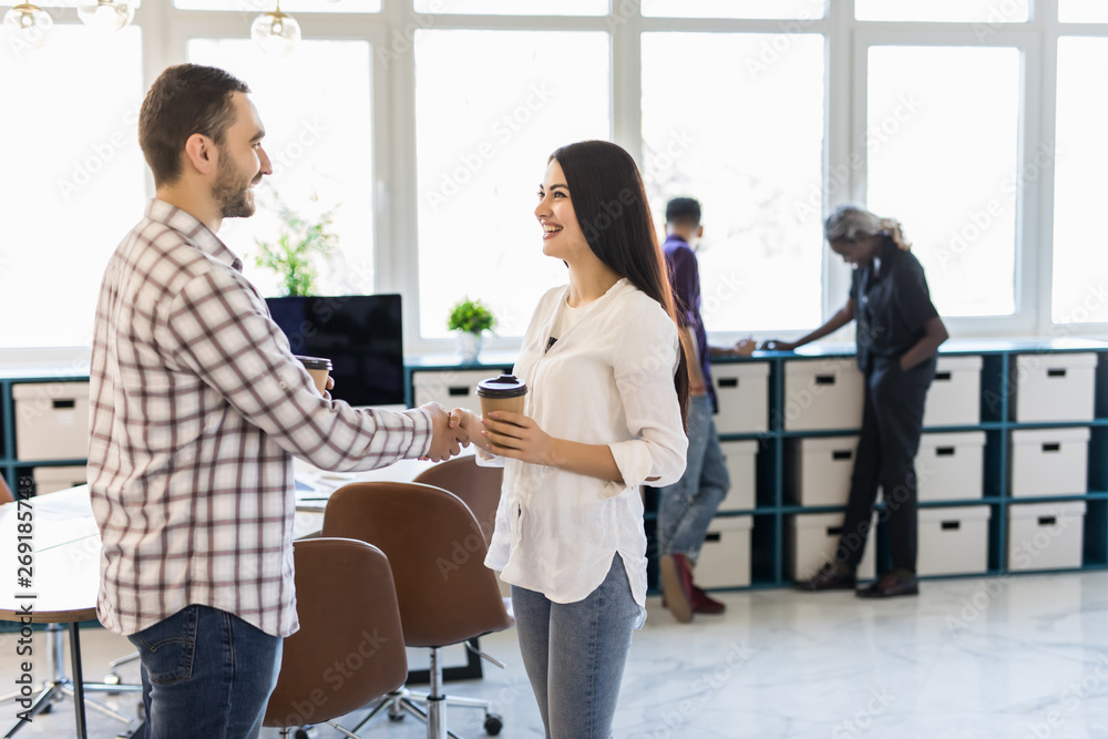 Smiling businesswoman shaking hand of colleague, greeting, getting acquainted with new employee during coffee break, smiling hr manager handshaking with job applicant Smiling businesswoman shaking hand of colleague, greeting, getting acquainted with new employee during coffee break, smiling hr manager handshaking with job applicant